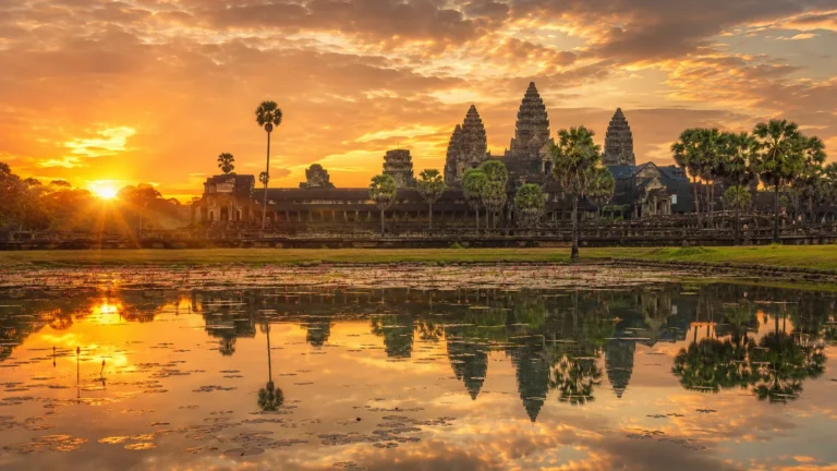 Angkor Wat reflected in the water at sunrise during Cambodia's dry season