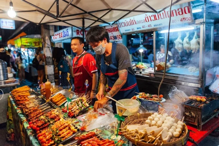 Traveller exploring affordable street food at Chiang Mai night market in Thailand